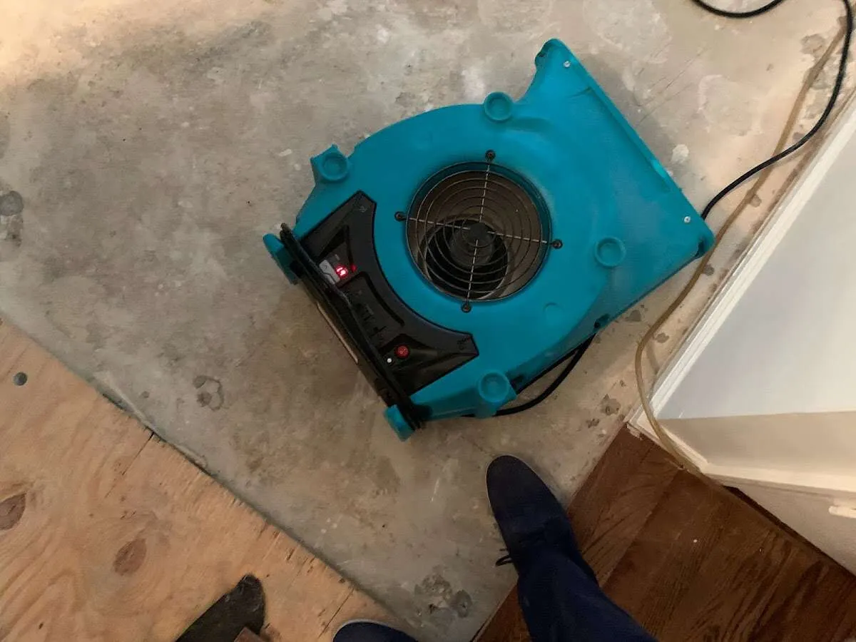 Air mover drying subfloor during Leak Detection & Repair in St. Thomas